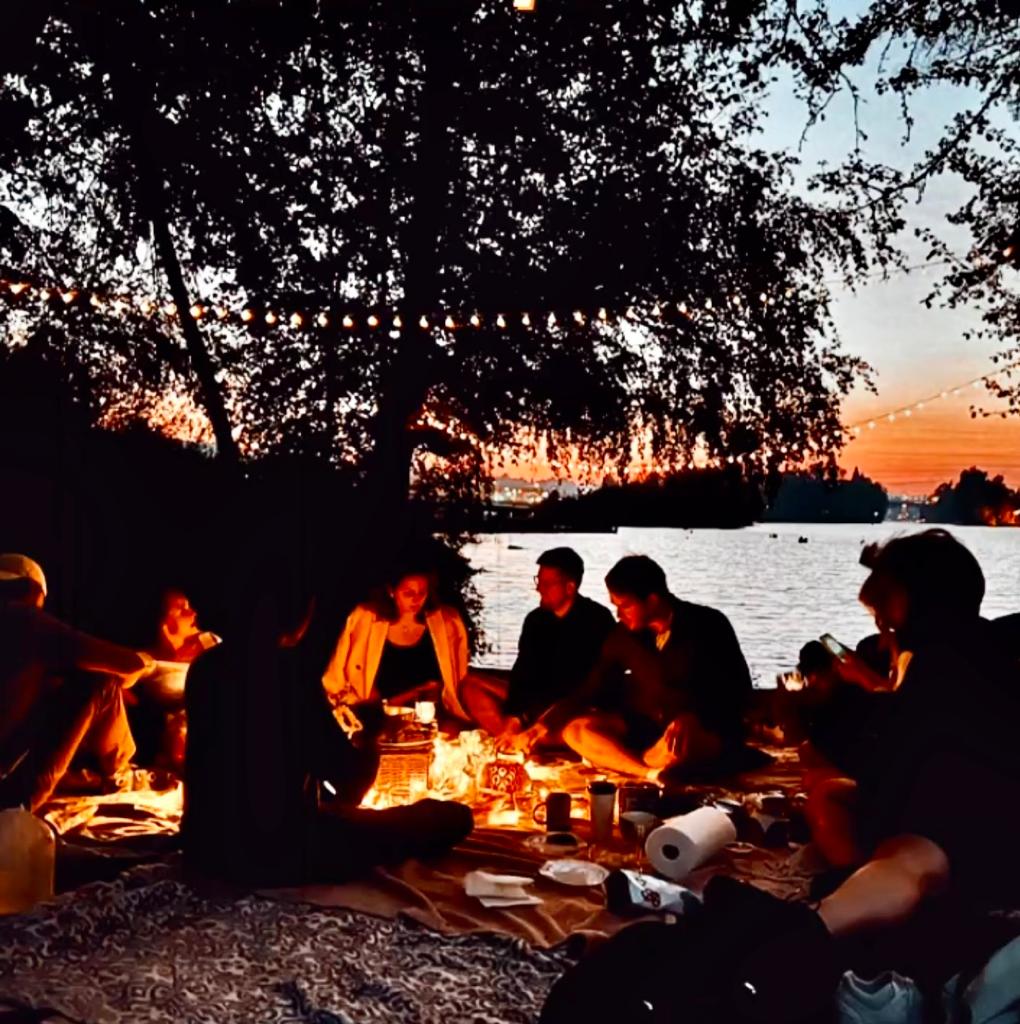 Friends enjoying a fall picnic at sunset